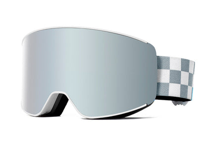 Silver ski goggles with a checkered case on a snowy surface with mountains in the background