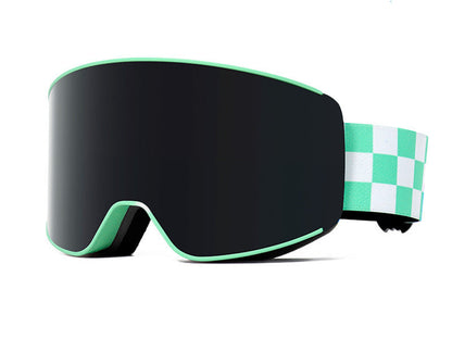 Black ski goggles with green strap and box on a white background